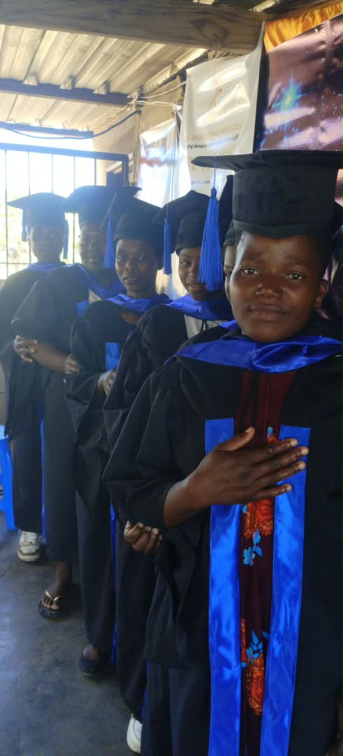 Graduates in gowns standing in a row